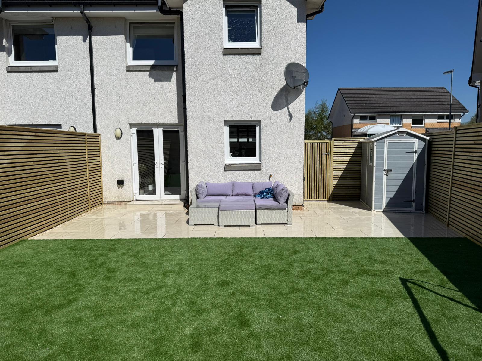 Artificial grass installation with porcelain paving and fencing, Darnley